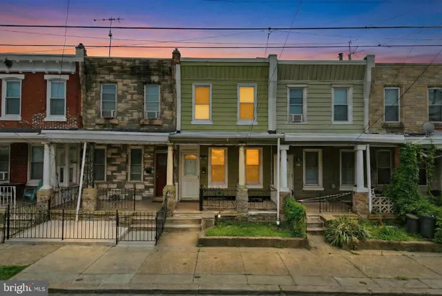 a front view of a building with a garden