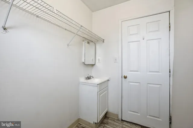 a white toilet sitting next to a bathroom sink and vanity