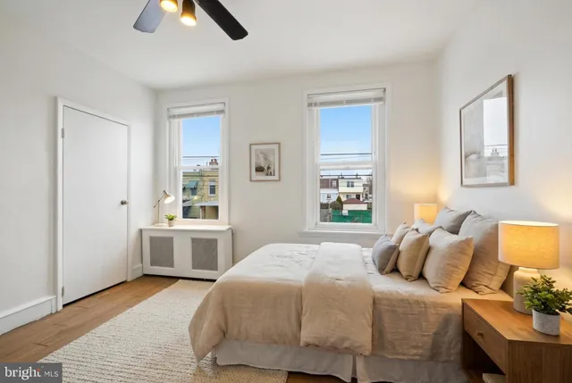 an empty room with ceiling fan and window