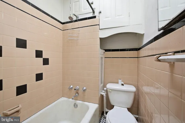 an empty room with a ceiling fan and wooden floor