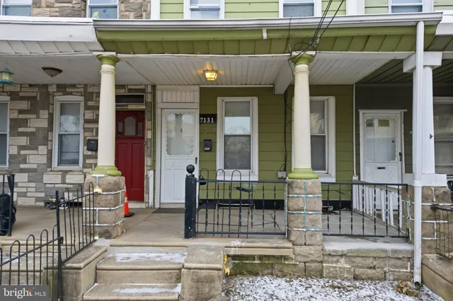a front view of a building with outdoor seating