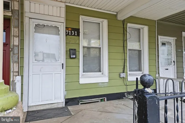 a room with two windows and a mirror