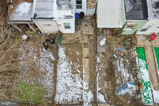 front view of a house with a yard and large trees