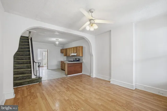 a front view of a building with a garden and plants