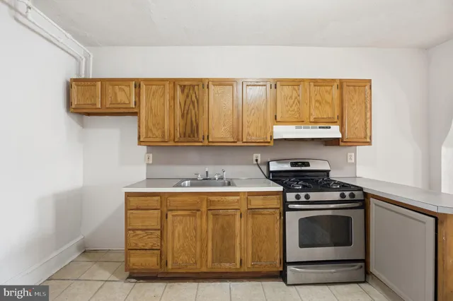 a kitchen with a stove a sink and a refrigerator