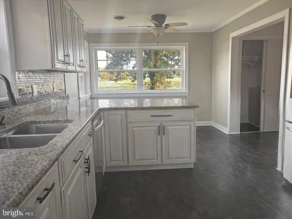 a kitchen with a sink cabinets and window