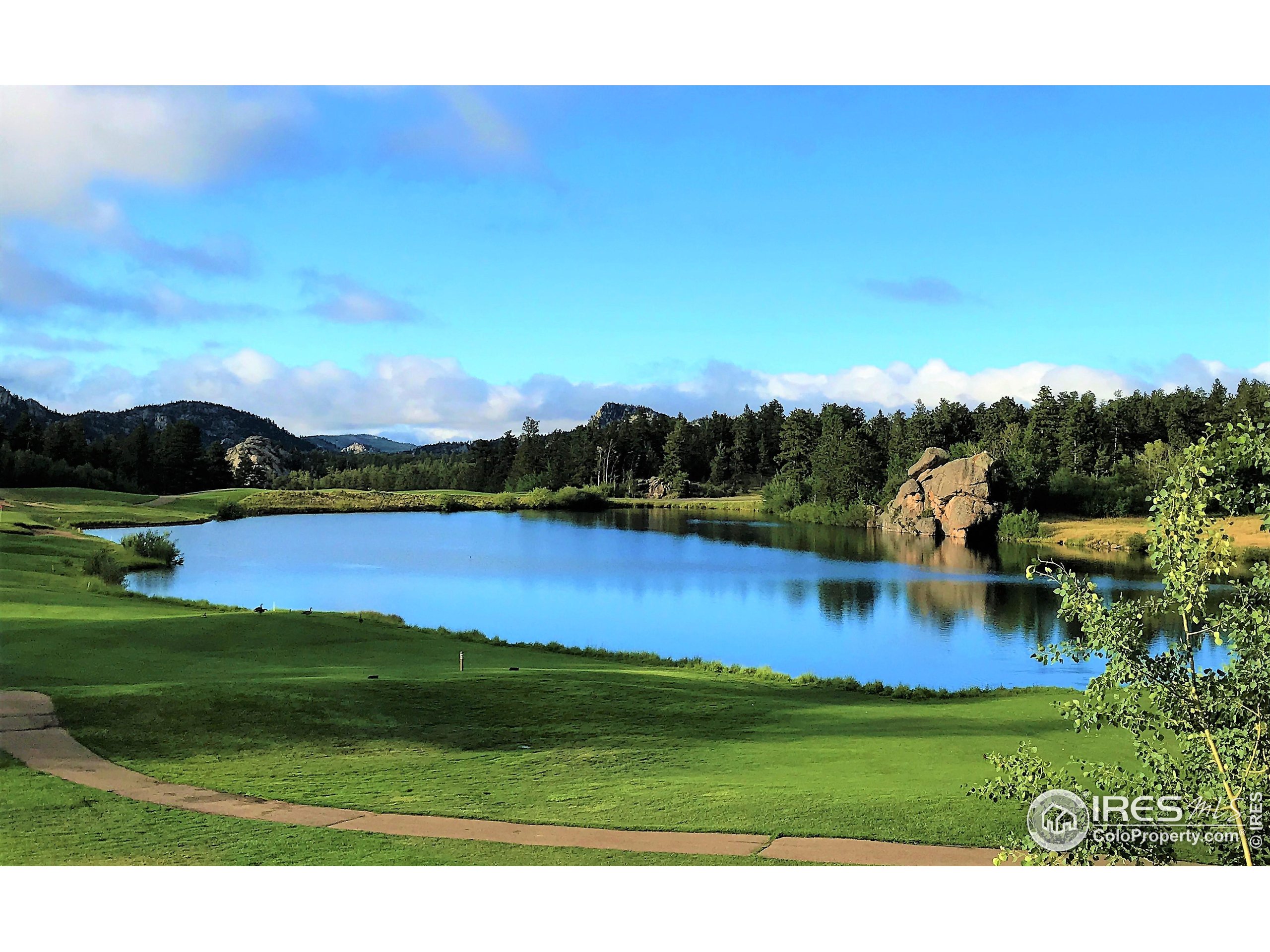 3 Fox Meadow Lane, Unit LOT 3 Red Feather Lakes, CO 80545 - Photo 17 of 25 a view of a lake with houses in the back