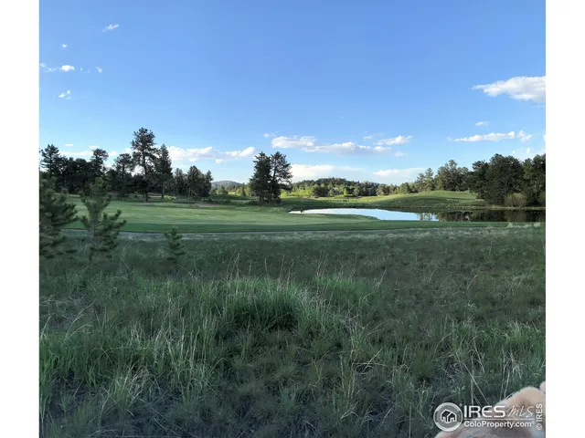 a view of a golf course with a lake