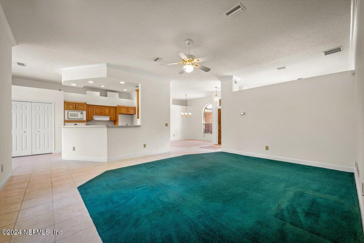 10967 Heathfield Road Jacksonville, FL 32225 - Photo 12 of 39 wooden floor in an empty room with a window