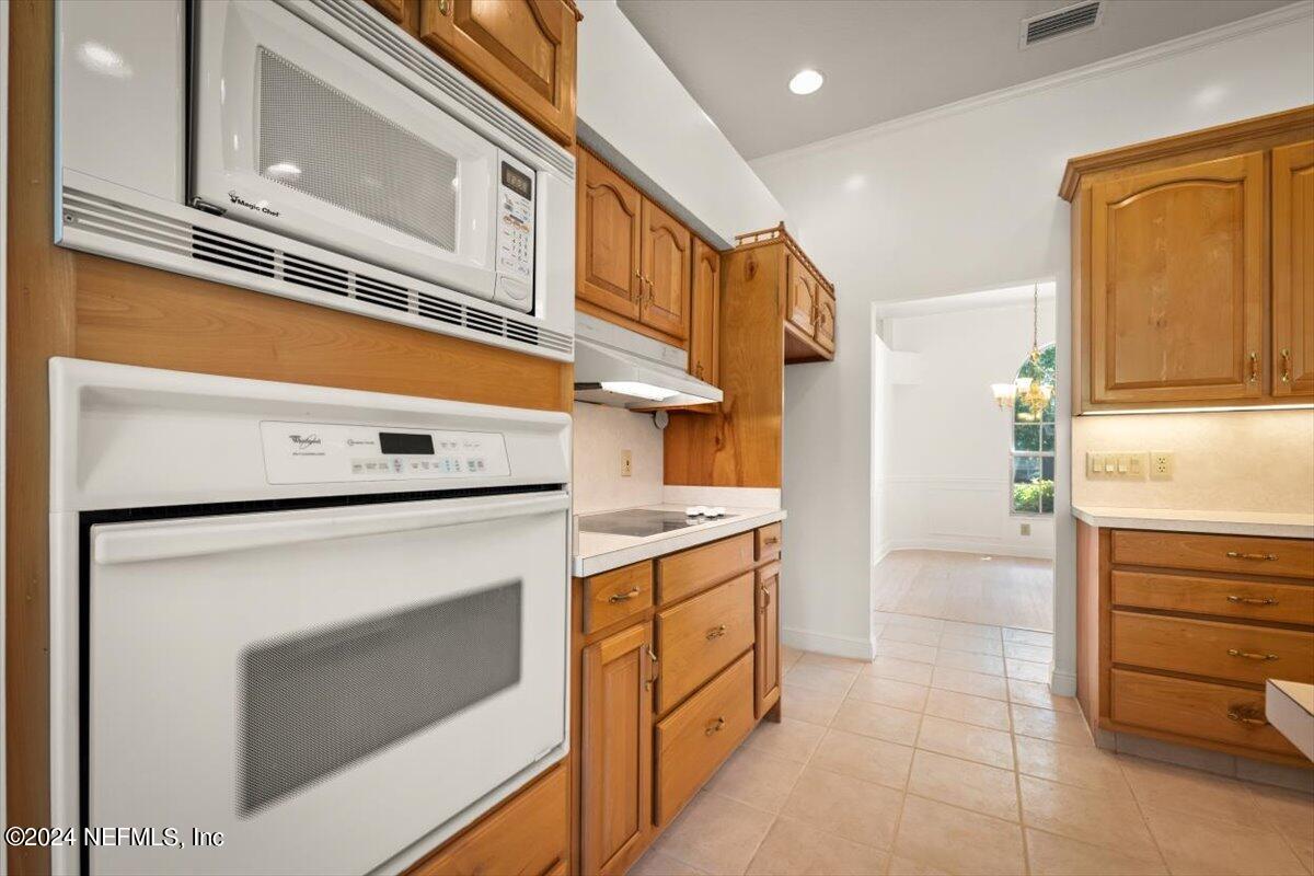 10967 Heathfield Road Jacksonville, FL 32225 - Photo 17 of 39 a kitchen with a stove cabinets and a refrigerator