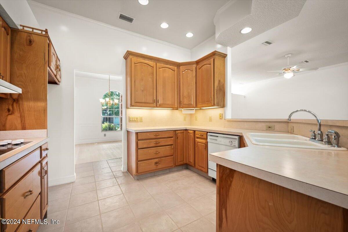 10967 Heathfield Road Jacksonville, FL 32225 - Photo 18 of 39 a kitchen with a sink a stove and cabinets