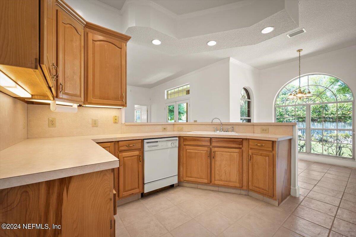 10967 Heathfield Road Jacksonville, FL 32225 - Photo 19 of 39 a kitchen with granite countertop a sink stainless steel appliances and cabinets