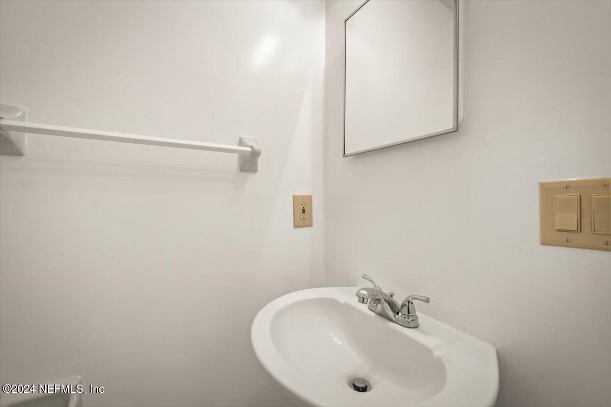 10967 Heathfield Road Jacksonville, FL 32225 - Photo 21 of 39 a bathroom with a sink and a mirror