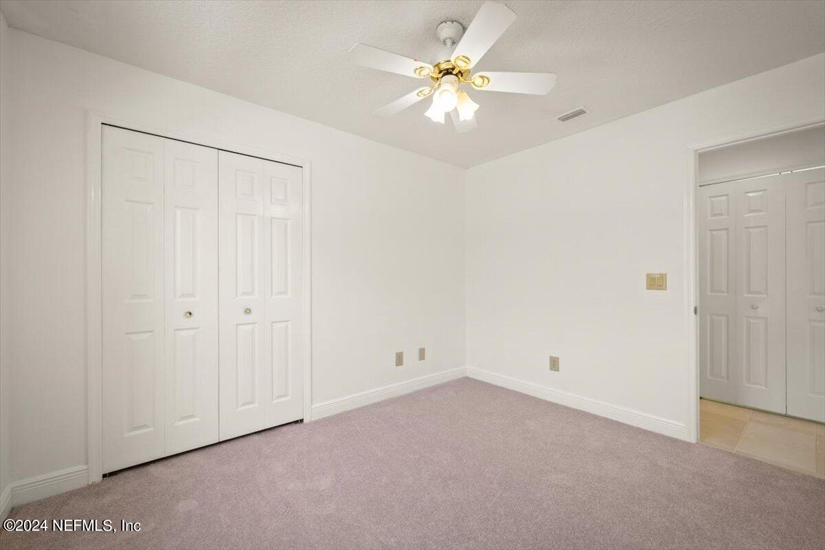 10967 Heathfield Road Jacksonville, FL 32225 - Photo 23 of 39 an empty room with chandelier fan