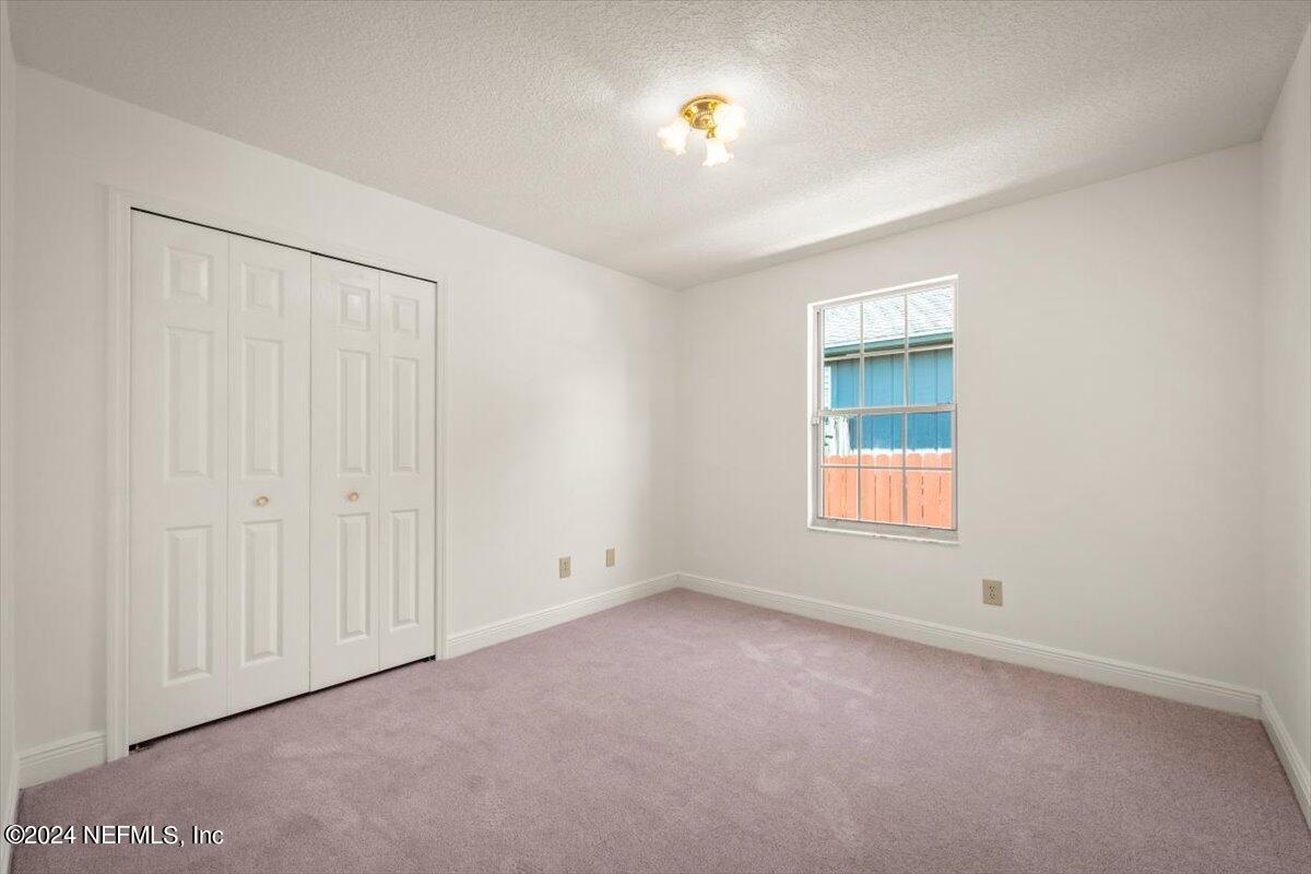 10967 Heathfield Road Jacksonville, FL 32225 - Photo 25 of 39 an empty room with windows