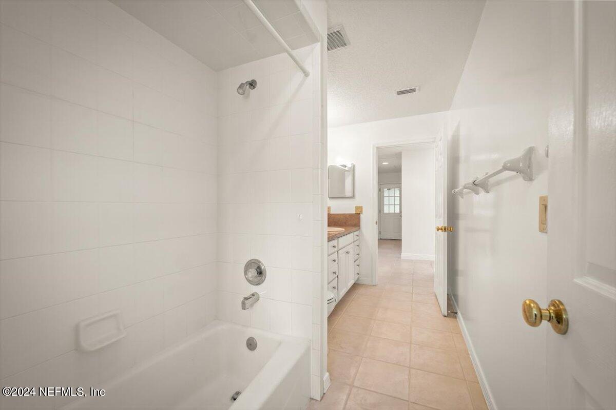 10967 Heathfield Road Jacksonville, FL 32225 - Photo 28 of 39 a bathroom with a bathtub and shower