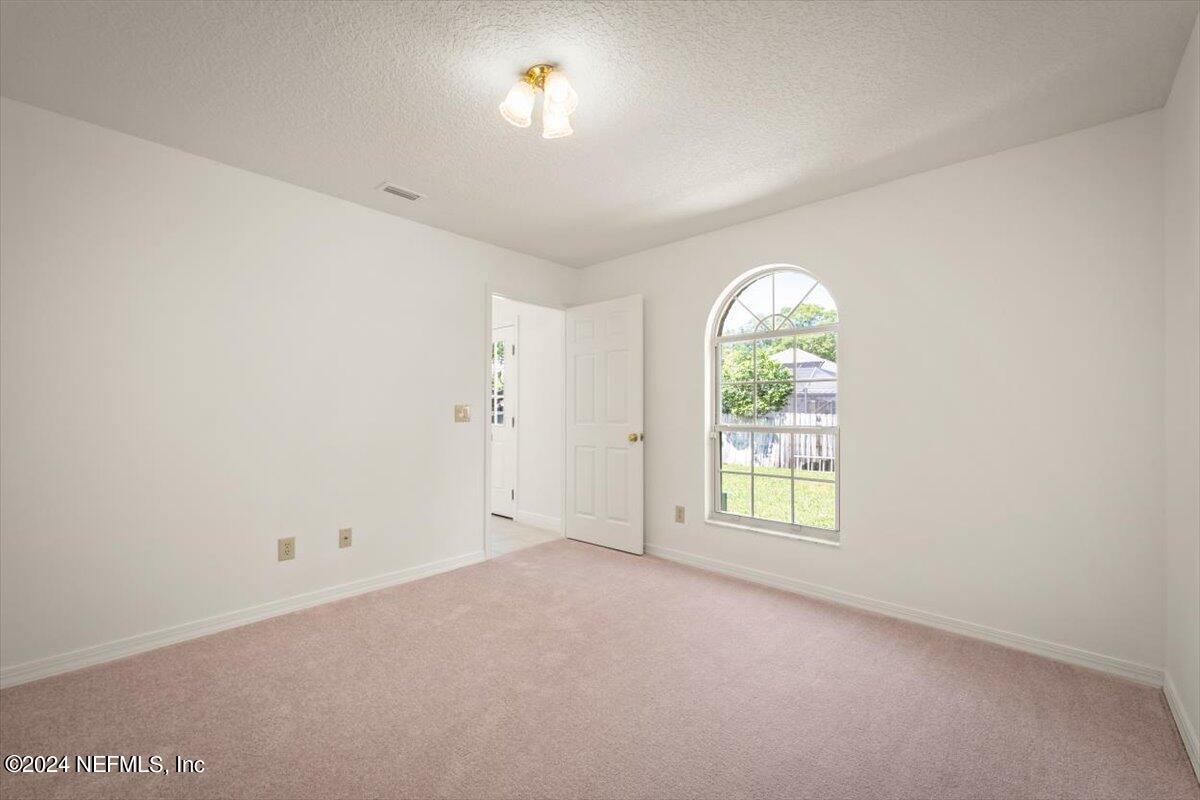 10967 Heathfield Road Jacksonville, FL 32225 - Photo 30 of 39 an empty room with windows