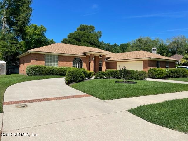 10967 Heathfield Road Jacksonville, FL 32225 - Photo 3 of 39 a front view of a house with a yard
