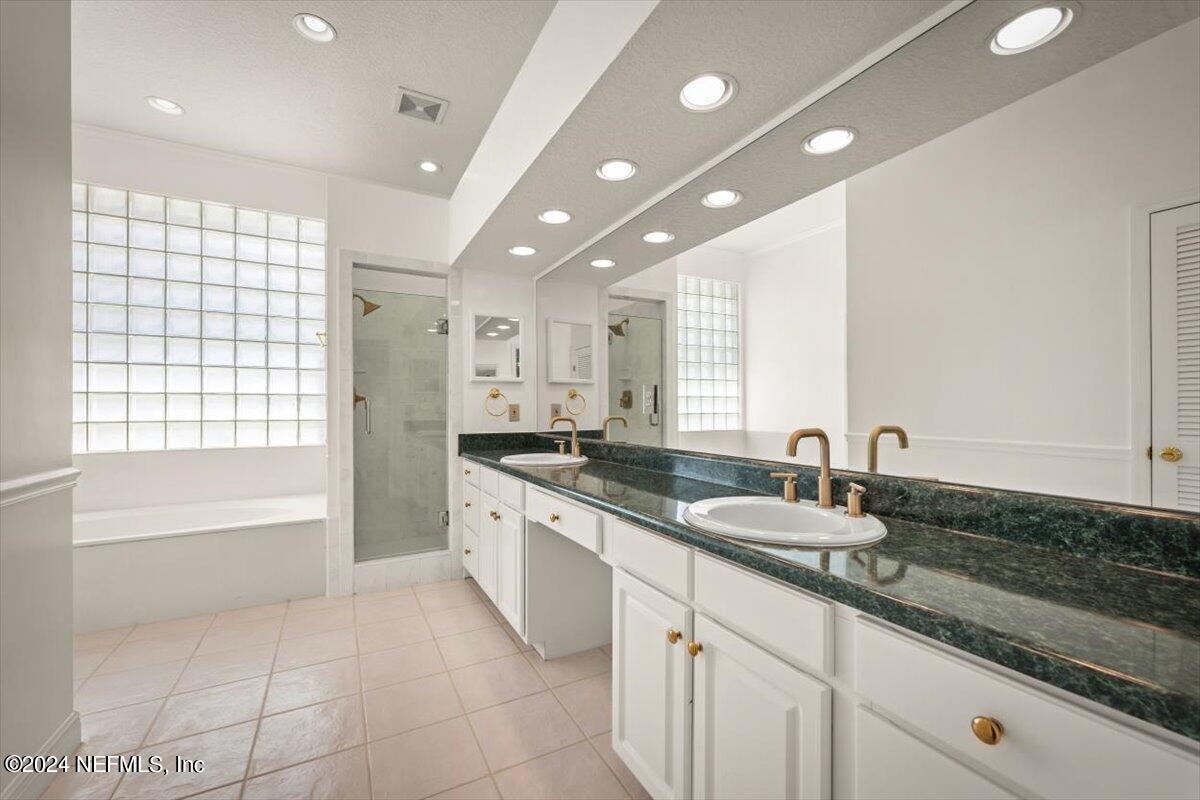 10967 Heathfield Road Jacksonville, FL 32225 - Photo 34 of 39 a bathroom with a granite countertop sink mirror and bathtub