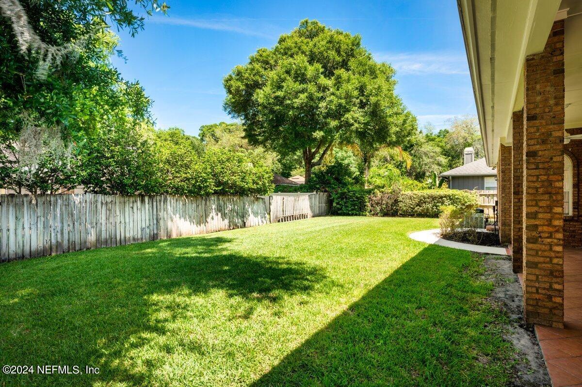 10967 Heathfield Road Jacksonville, FL 32225 - Photo 38 of 39 a view of yard with swimming pool and green space