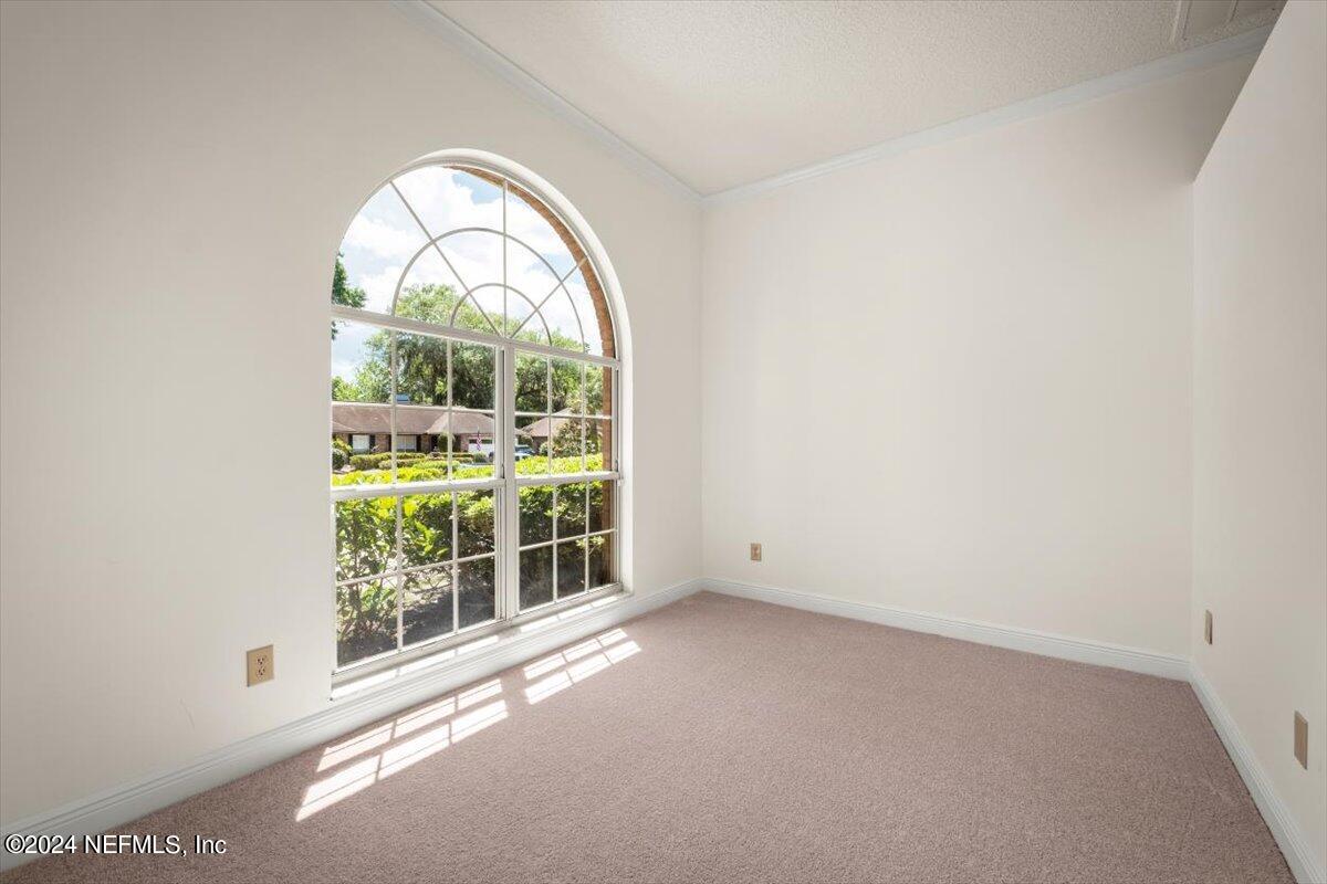 10967 Heathfield Road Jacksonville, FL 32225 - Photo 6 of 39 an empty room with windows