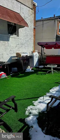 a view of a house with a yard and sitting area