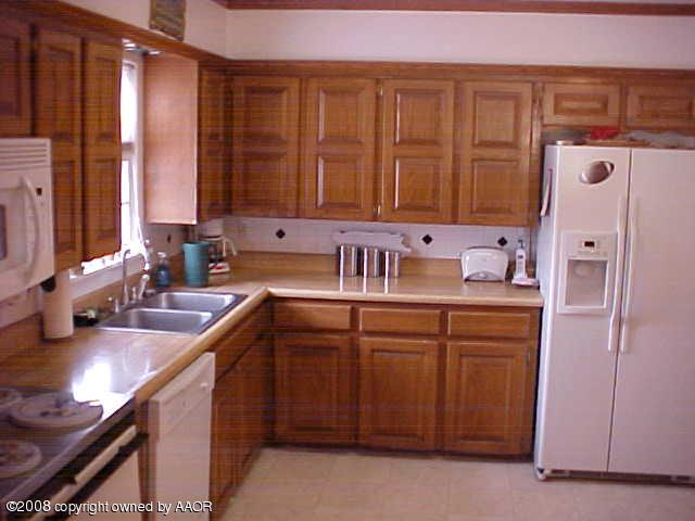4702 South Fannin Street Amarillo, TX 79110 - Photo 4 of 10 a kitchen with a sink cabinets and window