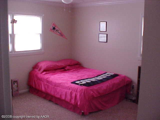 4702 South Fannin Street Amarillo, TX 79110 - Photo 7 of 10 a bedroom with a bed and a window