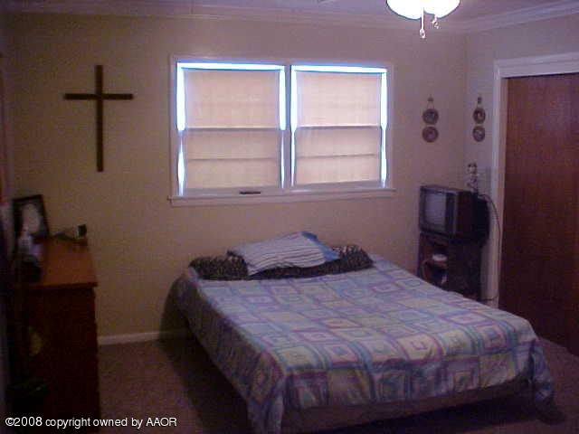 4702 South Fannin Street Amarillo, TX 79110 - Photo 8 of 10 a bedroom with a bed and a window