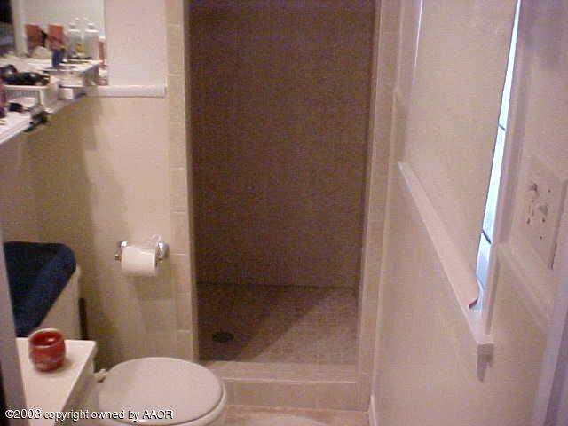 4702 South Fannin Street Amarillo, TX 79110 - Photo 10 of 10 a bathroom with a toilet and a shower