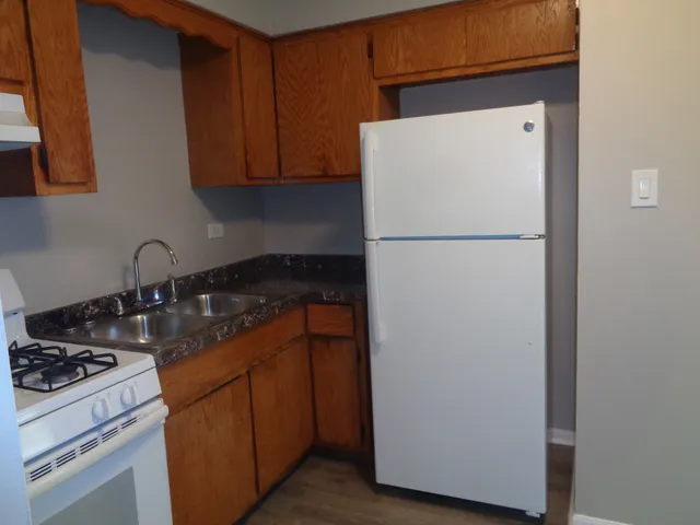 a white refrigerator freezer sitting inside of a kitchen
