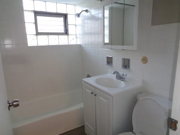 a bathroom with a sink toilet and bathtub