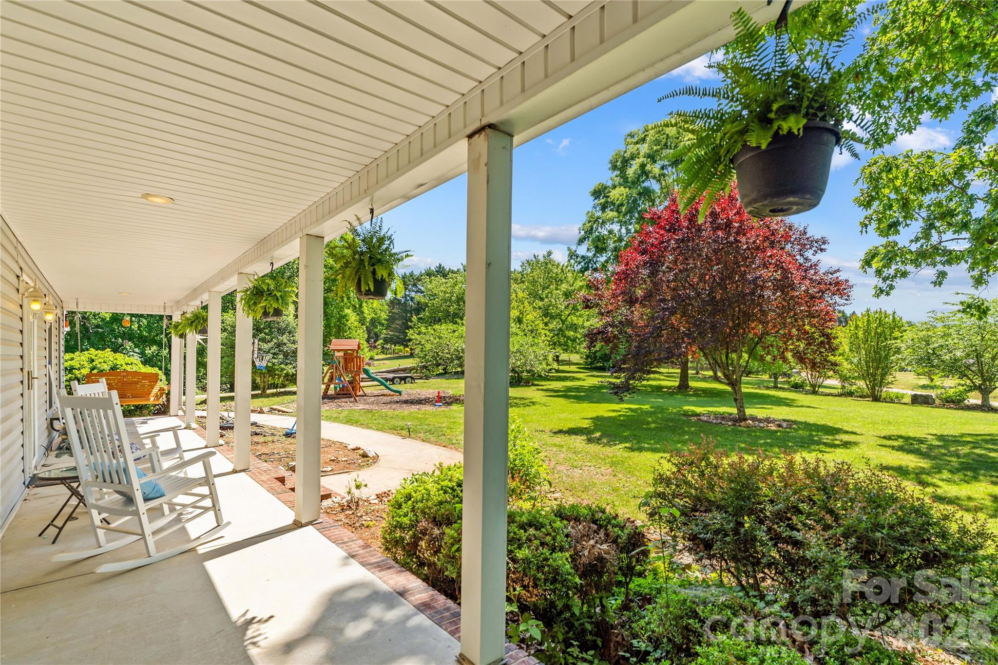 711 Spring Pointe Drive Stony Point, NC 28678 - Photo 3 of 47 a view of a patio with table and chairs potted plants and floor to ceiling window