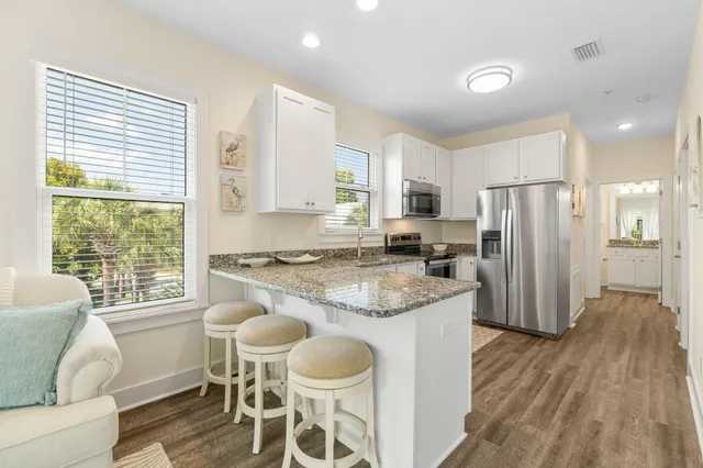a living room with furniture a flat screen tv and a rug