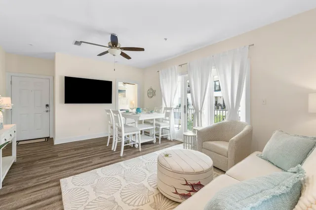 a kitchen with a dining table chairs and white cabinets
