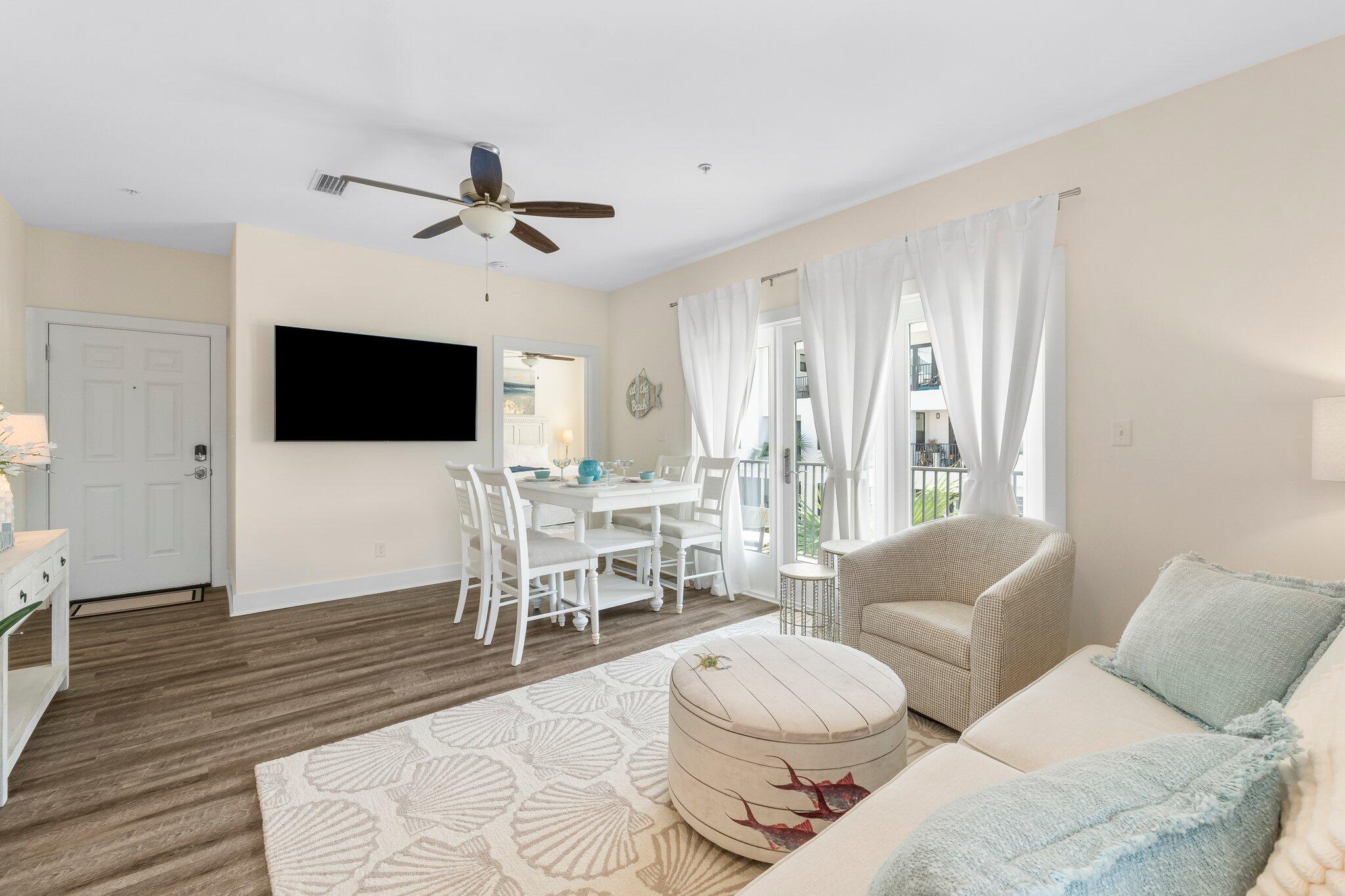 3958 West County Highway 30A, Unit 124 Santa Rosa Beach, FL 32459 - Photo 12 of 51 a living room with furniture a flat screen tv and a rug