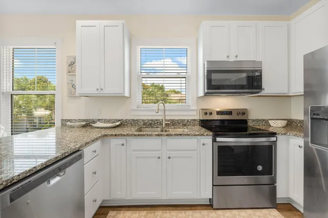 a kitchen with a sink cabinets and wooden floor