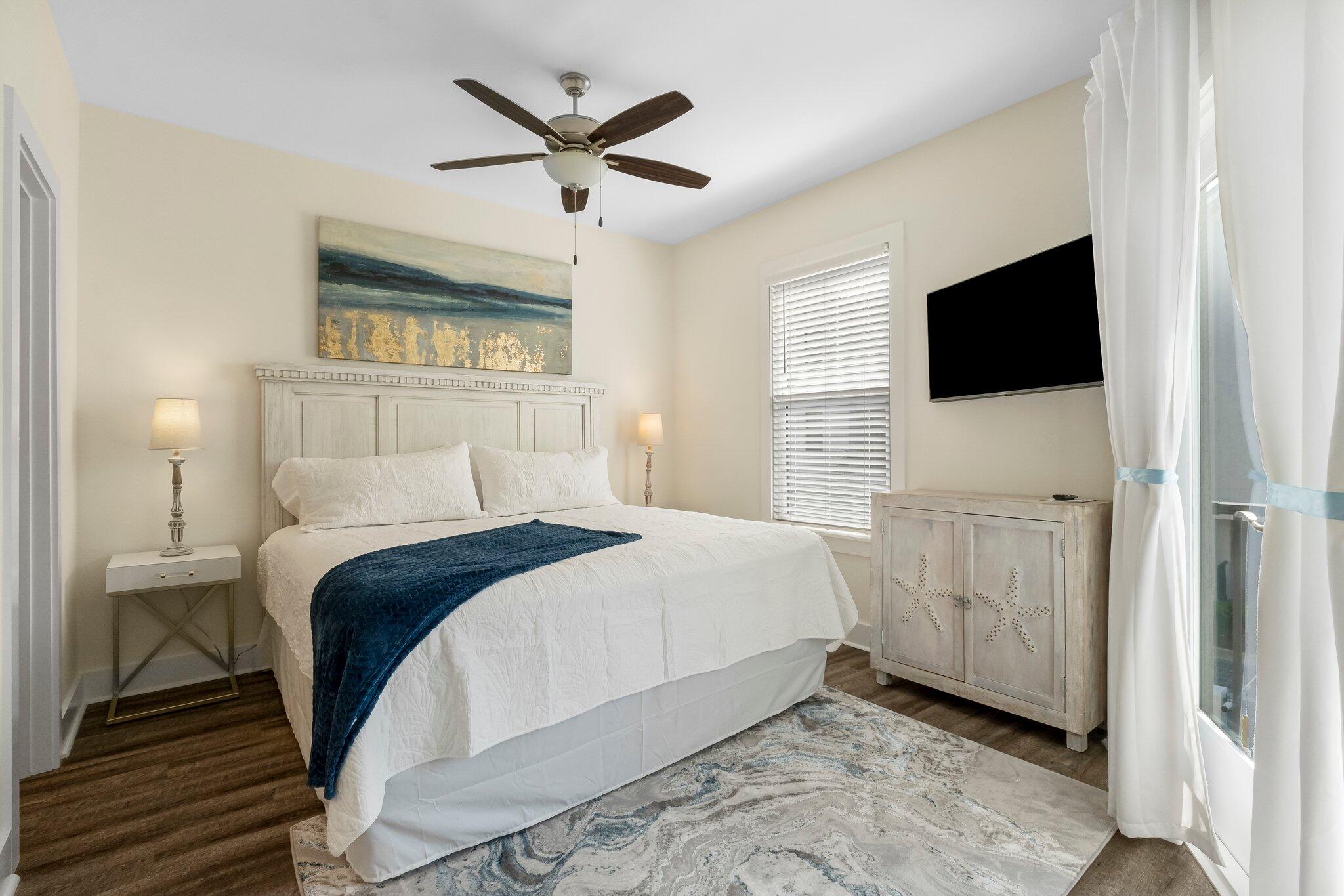 3958 West County Highway 30A, Unit 124 Santa Rosa Beach, FL 32459 - Photo 21 of 51 a bedroom with a bed and a flat screen tv