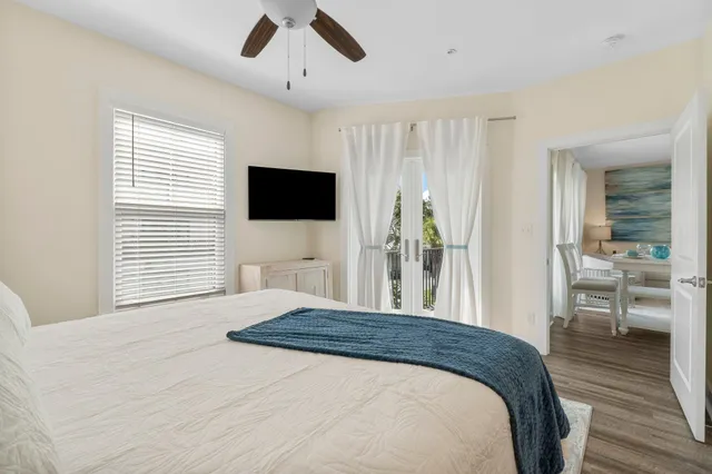 a bedroom with a large bed and a chandelier