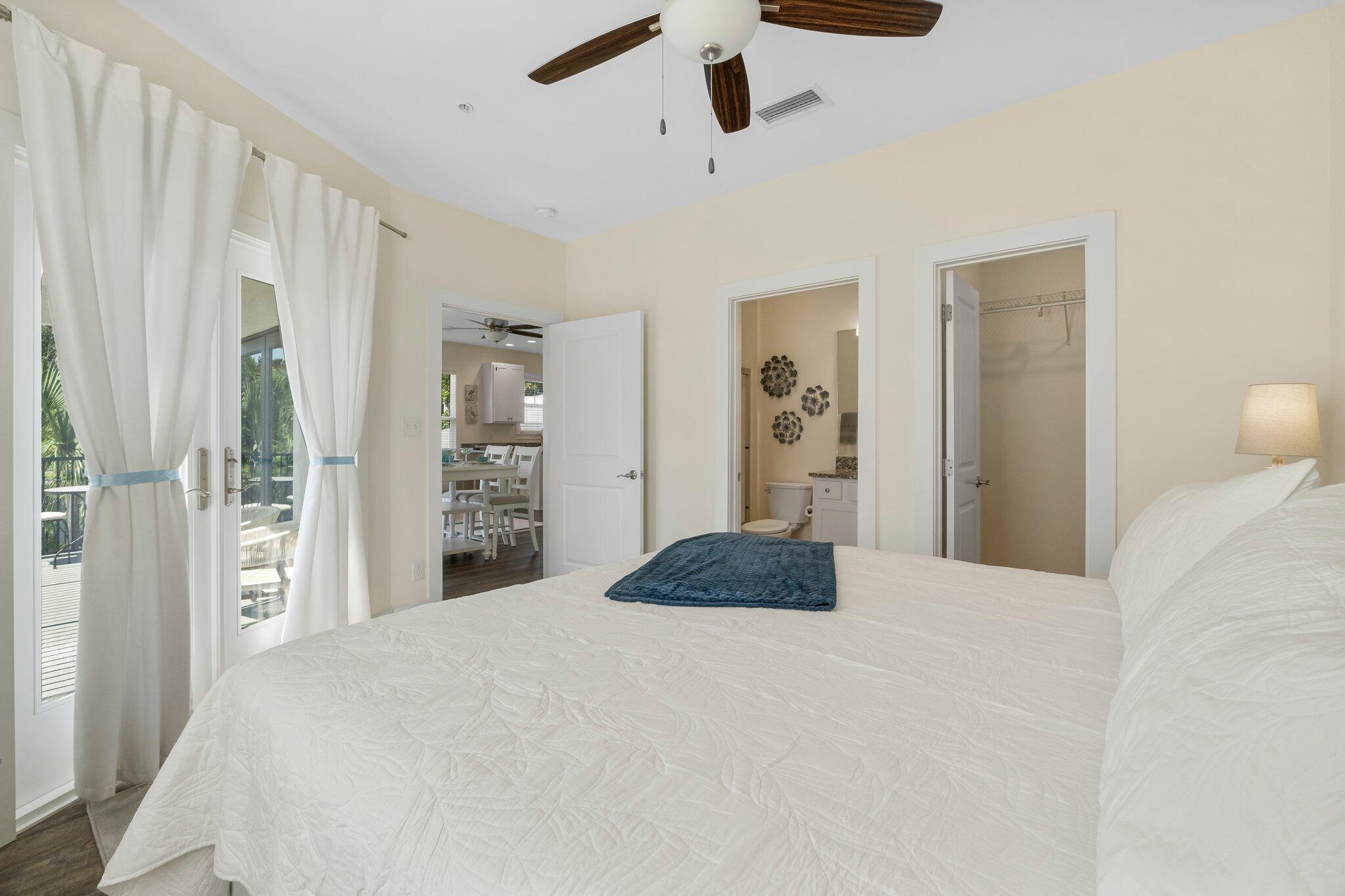 3958 West County Highway 30A, Unit 124 Santa Rosa Beach, FL 32459 - Photo 23 of 51 a bedroom with a large bed and a chandelier