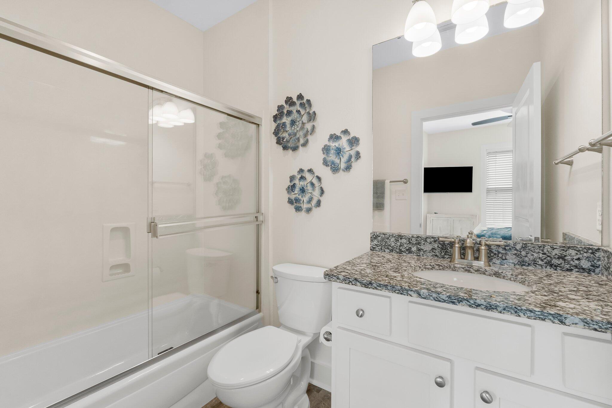 3958 West County Highway 30A, Unit 124 Santa Rosa Beach, FL 32459 - Photo 24 of 51 a bathroom with a granite countertop sink toilet and shower