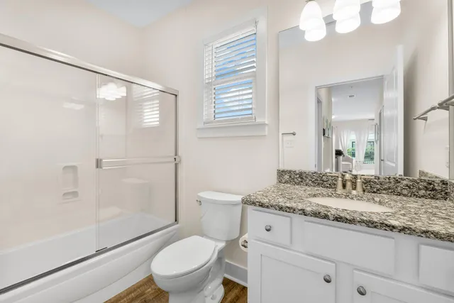 a bedroom with two beds and a chandelier