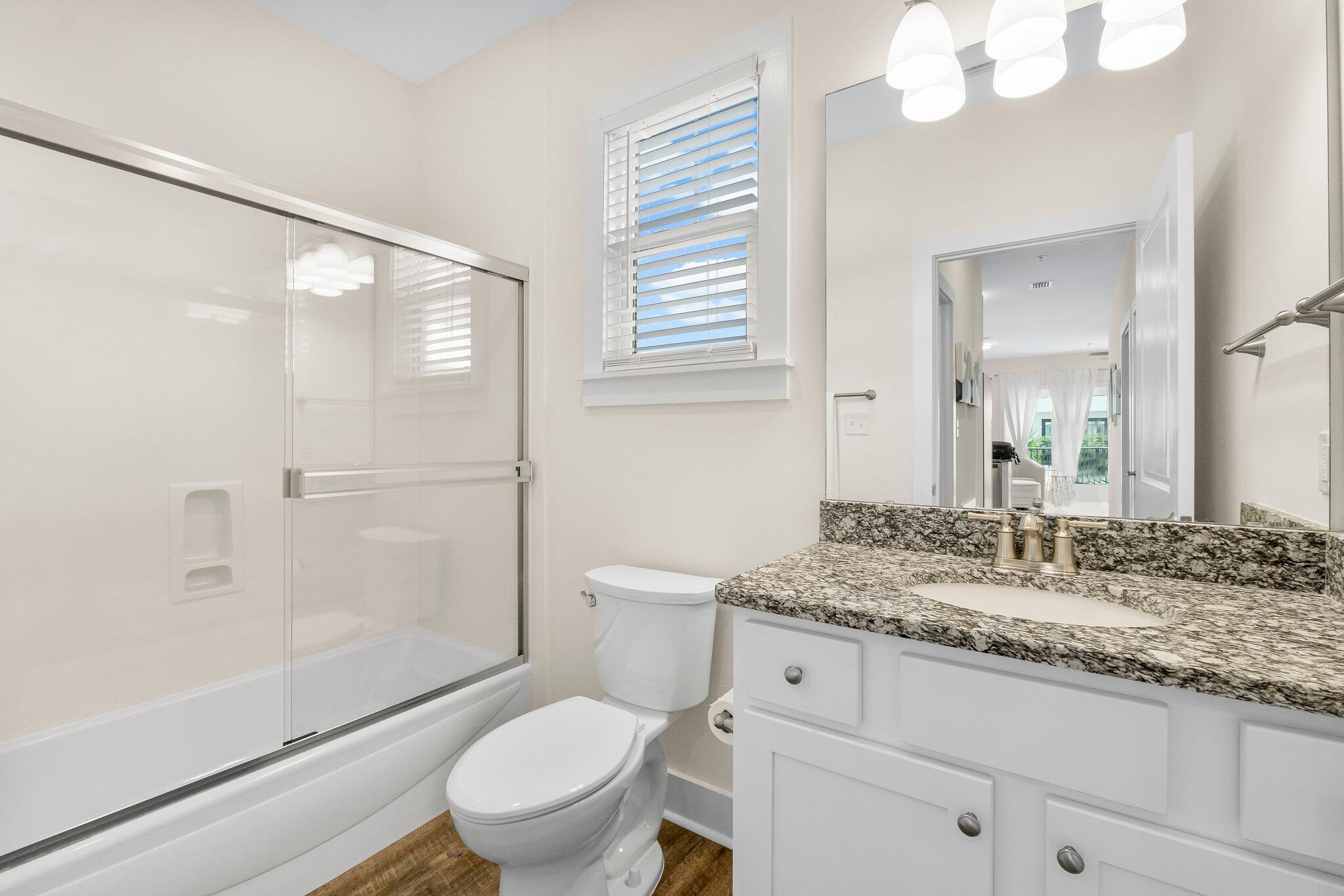 3958 West County Highway 30A, Unit 124 Santa Rosa Beach, FL 32459 - Photo 28 of 51 a bathroom with a granite countertop sink toilet a mirror and shower