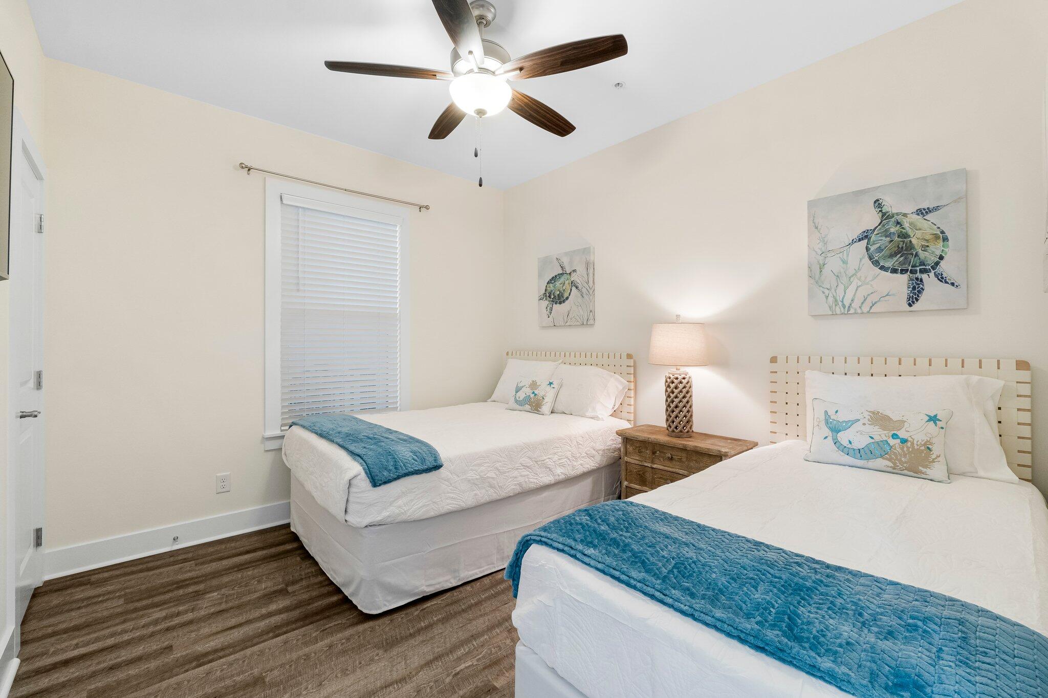 3958 West County Highway 30A, Unit 124 Santa Rosa Beach, FL 32459 - Photo 29 of 51 a bedroom with two beds and a chandelier