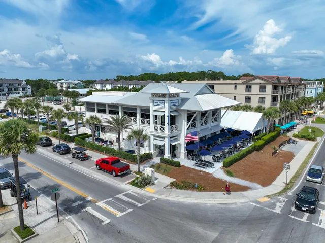 a view of a terrace with chairs and potted plants