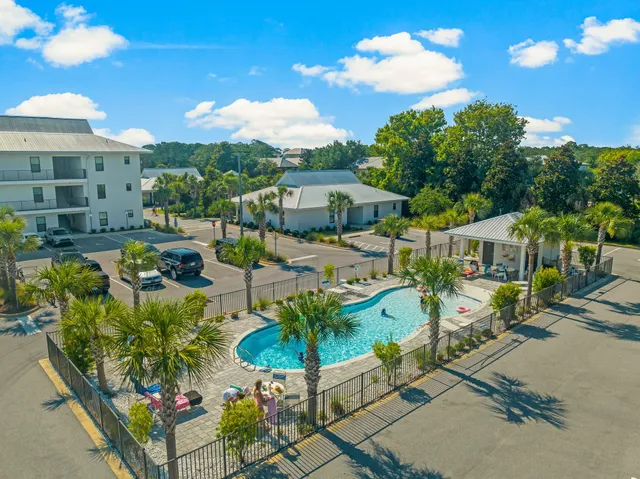 a view of a patio with table and chairs potted plants