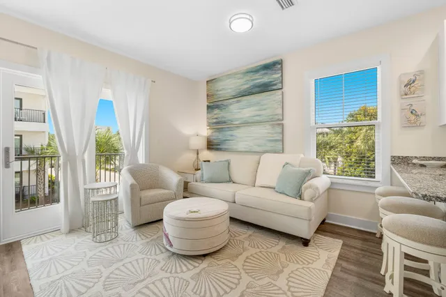 a kitchen with kitchen island granite countertop wooden floors and white stainless steel appliances