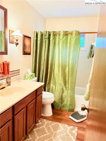 a bedroom with furniture and a flat screen tv