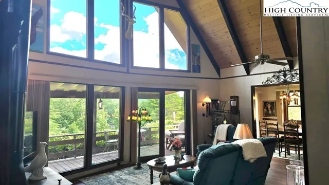 a living room with furniture and a floor to ceiling window