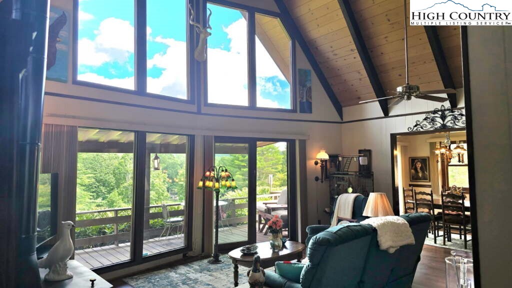 118 Pine Ridge Loop Newland, NC 28657 - Photo 2 of 50 a living room with furniture and a floor to ceiling window